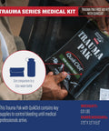 Trauma Pak first aid kit in black pouch with QuikClot sponge, held in hands; front view with size comparison circle.