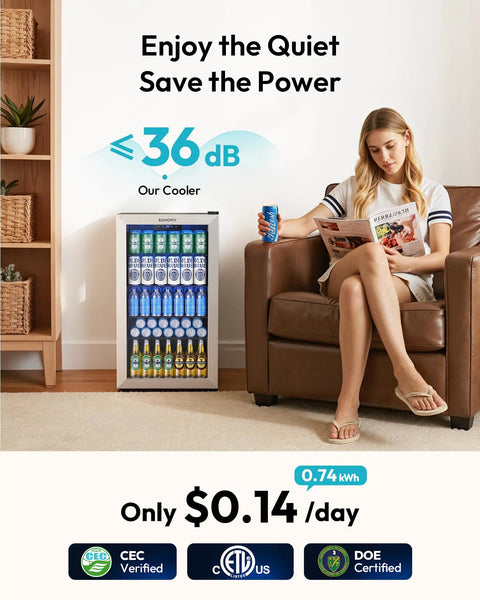 Mini Bev Fridge 130 Can Capacity Glass Door Cooler For Home Bar Office With Digital Temperature Control And Adjustable Shelves 3.2 Cu Ft Portable Compact Beverage Refrigerator Silver, shown in a living room setting.