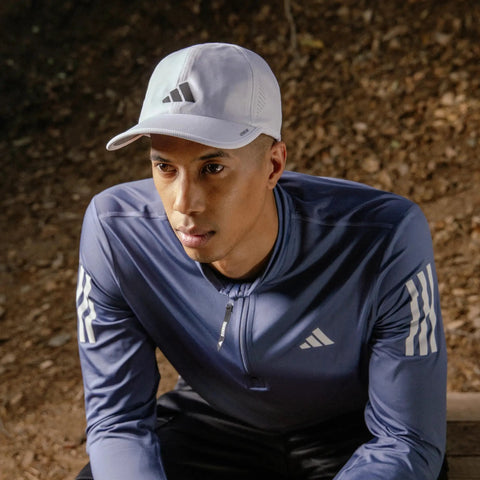 Man wearing Go To Men's Superlite Hat Ultra Lightweight Moisture Wicking Cap With Low Profile Crown And Superior Airflow