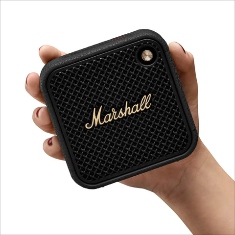 Willen II Portable Bluetooth Speaker With Rugged Waterproof And Dust Proof Design held in hand, front view, black and brass