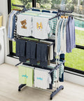 Top Shelf Oversized Four Tier Clothes Drying Rack With A Built Tough Foldable Frame Plus Side Wings For Hanging Laundry Towels Shoes And Quilts Roomy Air Drying Setup with shirts and towels.