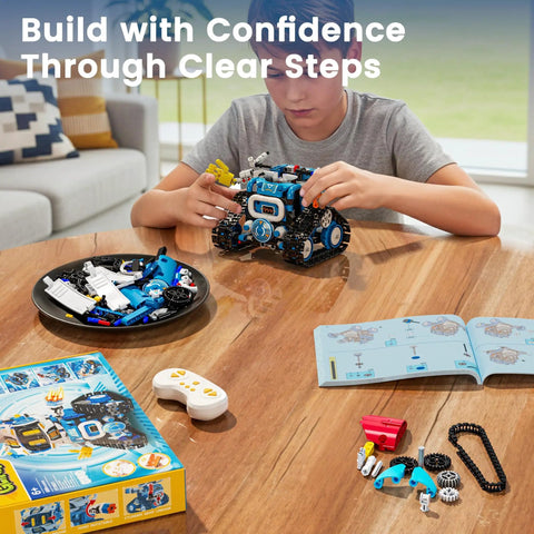 Five In One STEM Robotics Kit With App And Remote Control Build Code And Play Projects A Kid Friendly Gift For Ages 8 To 12 That Makes Learning Hands On Creative And Totally Fun This Holiday Season. Boy building blue STEM robot kit at a table