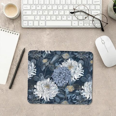 Blue and white floral mouse pad with gold chrysanthemum accent, luxury desk mat for home office, on a desk with accessories.