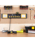 Heavy Duty Commercial Grade Power Station With Six Outlets And Two USB Ports Built In Cradle And Pivoting 1000 Lumen LED Lights Ideal For Garages, Workshops, And Job Sites installed on a workshop pegboard wall.