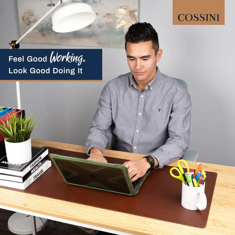 Man working at desk with XL Desk Pad 17 X 36 Inch Large Vegan Leather Desk Mat For Home Office And Computer Setup, waterproof non-slip mat.