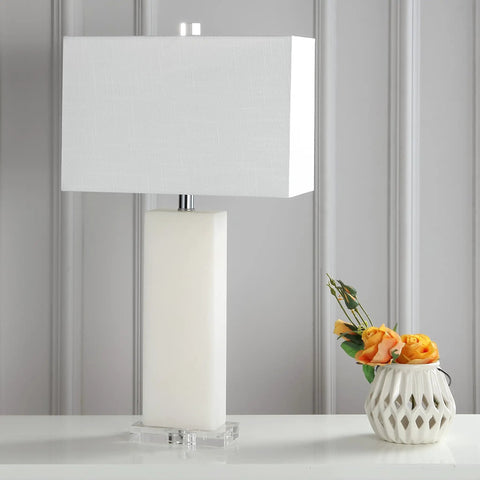 White Alabaster 27 Inch Rectangular Table Lamp With White Linen Shade on a table next to a vase with flowers