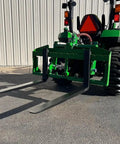 No Hassle Dual Mount Tractor Pallet Forks For Front Loader And Three Point Hitch featuring sturdy blades on a tractor.