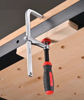 Built Tough Heavy Duty F Clamps Pack A Knockout 630 Pound Grip with rubber pads securing wood to workbench.