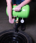 Person using a green 5 Gallon Tire Bead Seater And Bead Blaster For 4 To 24.5 Inch Tires 150 PSI Capacity CE Certified Steel Tank.