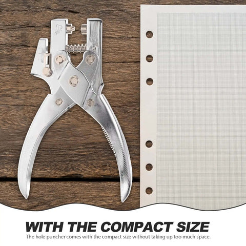 Handheld Metal Hole Puncher For Office And Crafts next to lined paper, showcasing compact design and titanium alloy material.
