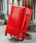 Vintage Inspired 3-Piece Luggage Set With Hardside Red Crocodile-Embossed Finish Lightweight Spinner Suitcases Including 26-Inch Large, 20-Inch Carry-On, And 12-Inch Underseat Train Case For Retro Travel standing on stone steps