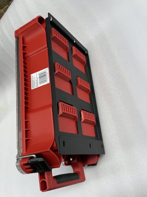 Side view of Packout Mounting Plate for Milwaukee System, black heavy-duty metal base attached to red toolbox with handle.