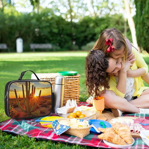 Family picnic in park with Insulated Lunch Tote With Large Capacity And Detachable Handle, Sunset Cactus design on blanket