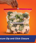 Gallon Slider Storage Bags Set Of 66 filled with broccoli and cauliflower, secure zip closure, writable label on clear bag held by hand.