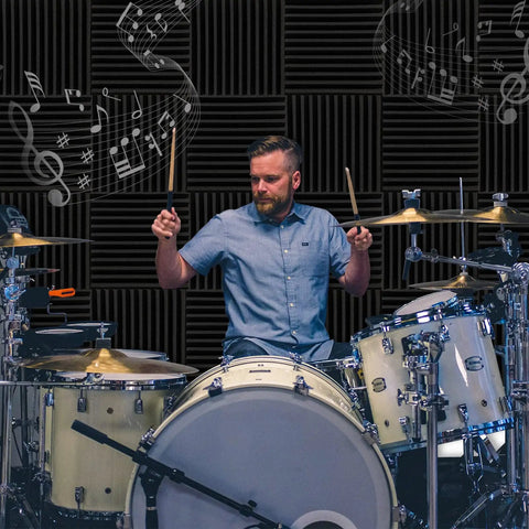 Drummer playing in front of 50 Pack High Density Acoustic Foam Panels 2x12x12 Inches Soundproof Wedges For Studio And Home Office.