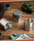Heavy Duty Four Piece Trailer Wheel Bearing Protectors With Chromed Metal Dust Caps on wood surface with tools and toy car.