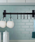 Black wall-mounted kitchen rail with 8 hooks holding mugs and utensils, part of Kitchen Utensil Holder Hanger, Pot and Pan Rack Pack of 2