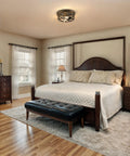 Industrial Three Bulb Ceiling Light With Vintage Metal Cage, Oil Rubbed Bronze Flush Mount Fixture in a cozy bedroom setting.