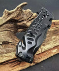 Black Serrated Folding Knife With Dual Edge Design For Outdoor Camping, Fishing And Hunting on wooden background