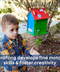 Bulk 12 Kid Friendly Bird House Craft Kits With Unfinished Wood Bird Houses, Paint Strips, Brushes, And Simple Instructions For A Hands On Build And Paint Project Great For Classrooms, Parties, And Family DIY Fun. Child beside painted wooden birdhouse craft kit outdoors