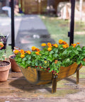 Two Pack Rustic Barrel Planters With Legged Design For Outdoor Garden Backyard Metal Half Barrel Flower Pot Planter Box Brown 15.43 Inch Long Each With Ample Planting Space Durable Anti Rust Coated Iron on patio table