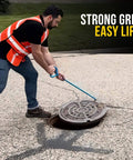 Worker using 36 Inch Manhole Hook Tool Hex Alloy Steel Heat Treated for Durable Lifting of Manhole Covers Storm Drains on construction site