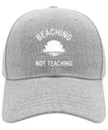 Gray cap with 'Beaching Not Teaching' design, lightweight, breathable. Cool Lightweight Baseball Cap For Men With A Modern Design.