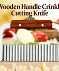 French fry slicer with wooden handle and stainless steel crinkle blade, front view