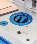 Close-up of locking router plate insert kit with twist locks for router table, aluminum construction, dust control features.