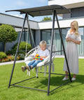 Child sitting on Chill Outdoor Hammock Chair With Stand And Canopy, Heavy Duty 660 Lb Capacity Cushioned Swing Chair in yard