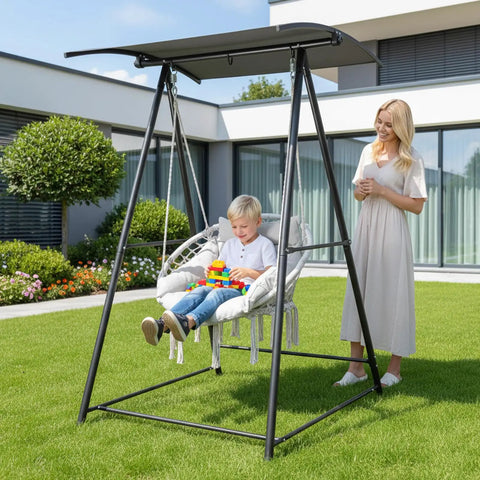 Child sitting on Chill Outdoor Hammock Chair With Stand And Canopy, Heavy Duty 660 Lb Capacity Cushioned Swing Chair in yard
