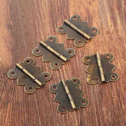 Close-up of Forty Piece Mini Butterfly Door Hinges in Antique Bronze for cabinets, drawers, jewelry boxes, and furniture fittings