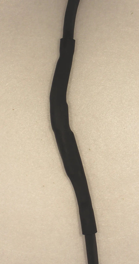 Direct Burial Wire Splice Kit For 18 To 14 AWG with black outer sleeve for outdoor cord repair and extension, shown installed.