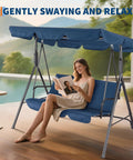 Woman relaxing on Three Seat Outdoor Swing Chair With Adjustable Canopy Stable Metal Frame Heavy Duty Stand Perfect Backyard Patio And Lawn Seating For Adults Blue Built For Comfort And Easy Year Round Kick Back Relaxation In The Sun