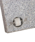 Close-up of Heavy Duty Granite Patio Umbrella Base With Handle And 2 Casters, showcasing the caster wheel embedded in grey stone.