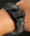 Survival Paracord Bracelet With Compass And LED Light on wrist, showcasing reflective cord and multi tool features for camping and hiking.