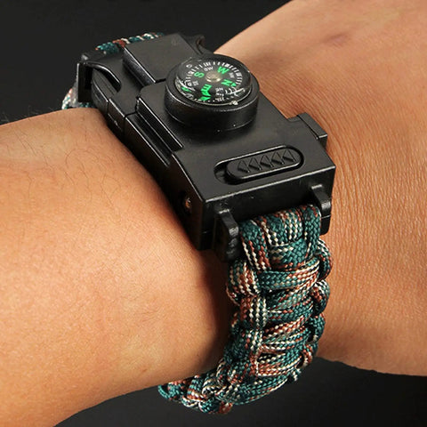 Survival Paracord Bracelet With Compass And LED Light on wrist, showcasing reflective cord and multi tool features for camping and hiking.