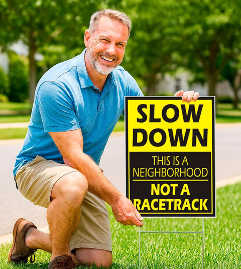 Man placing Set Of 3 Please Slow Down Signs For Neighborhoods With Metal H Stakes 12x8 Inch Plastic Double Sided Street Slow Signs