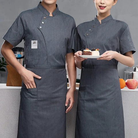 Men's Short Sleeve Chef Jacket Gray Breathable Kitchen Work Uniform Durable Restaurant Coat Sweat Wicking Culinary Staff Apparel Built Tough For The Daily Grind worn by two chefs in a kitchen setting.