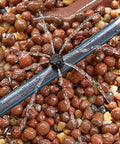 Close-up of 100 Pcs Adjustable Drip Irrigation Emitters Sprinklers For One Quarter Inch Barbed Hose Micro Drip System installed.