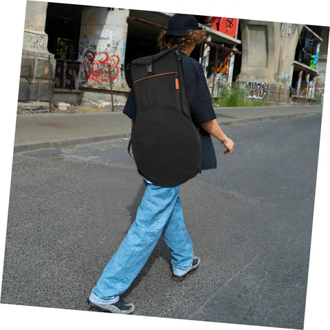 Person walking with a black Road Ready Portable Dumb Drum Bag For Silent Practice Pad Storage In Slick Oxford Fabric.