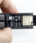 Three Pack ESP32 S3 Dev Board N16R8 MCU with dual mode WiFi Bluetooth Type C held in hand for Arduino IoT projects.