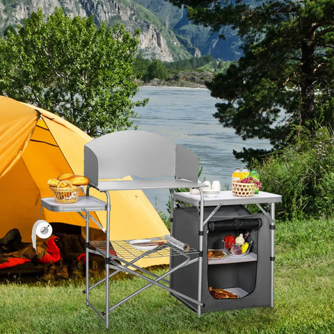 Folding Grill Table With 26 Inch Tabletop And Detachable Windscreen for camping kitchen next to a tent, outdoor setting.