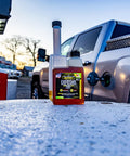 Top Shelf Diesel Fuel Additive And Daily Tune Up Formula Keeps Your Rig Running Slick Boosts Mileage And Sweeps Away Carbon Gunk For A Rock Solid Highway Cruise In A 16 Oz Bottle on gas station pump.