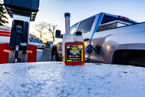 Top Shelf Diesel Fuel Additive And Daily Tune Up Formula Keeps Your Rig Running Slick Boosts Mileage And Sweeps Away Carbon Gunk For A Rock Solid Highway Cruise In A 16 Oz Bottle on gas station pump.