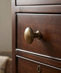 Classic Round Antique Brass Cabinet Knobs Set Of 6 With 1 1/4 Inch Head Diameter Vintage Aged furniture hardware on wooden drawer.