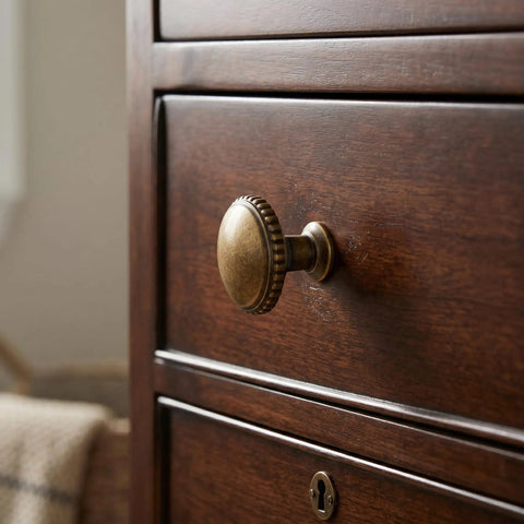 Classic Round Antique Brass Cabinet Knobs Set Of 6 With 1 1/4 Inch Head Diameter Vintage Aged furniture hardware on wooden drawer.