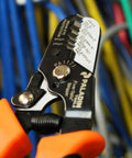 ProGrip Workhorse 5-In-1 Fiber Optic Stripper with dual durometer grips in use, displaying cable sizes and details.