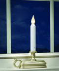 Battery Operated LED Window Candle With Dusk To Dawn Sensor And Hot Spot Flame Technology In Amber Or White Finish on windowsill
