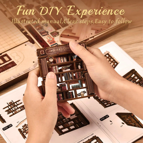 Hands holding miniature bookshelf from Cozy Chill Book Nook Kit For Adults, DIY Miniature Dollhouse Kit, over the assembly guide.